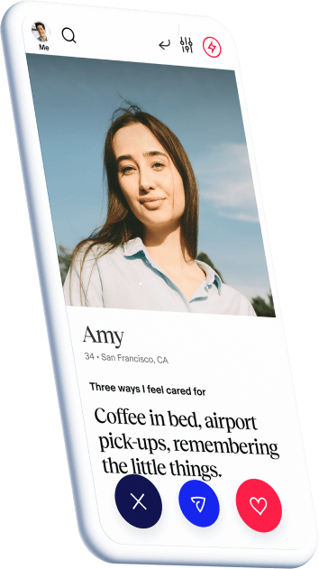 A phone displaying the dating profile of Amy, 34 years, from California. She feels cared for by things like coffee in bed, airport pick-ups and remembering the little things.